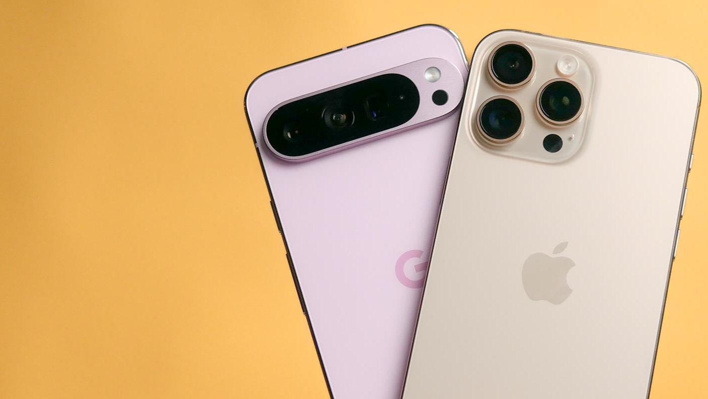 Two smartphones, one pink and one gold, on an orange and yellow background